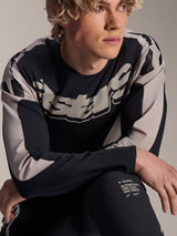 Alpinestars A-Supra Melt Jersey, Long Sleeve MTB Jersey, Black with light grey graphics, worn by model, featuring bold chest logo and 'One Goal. One Vision.' branding, performance mountain bike apparel
