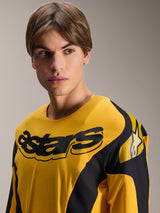 Alpinestars Limited Edition A-Supra Melt Gold Jersey, Long Sleeve MTB Jersey, Dark Yellow with black racing-inspired graphics, featuring a black 'astars' wordmark on the chest and star logo on the shoulder, worn by a male model