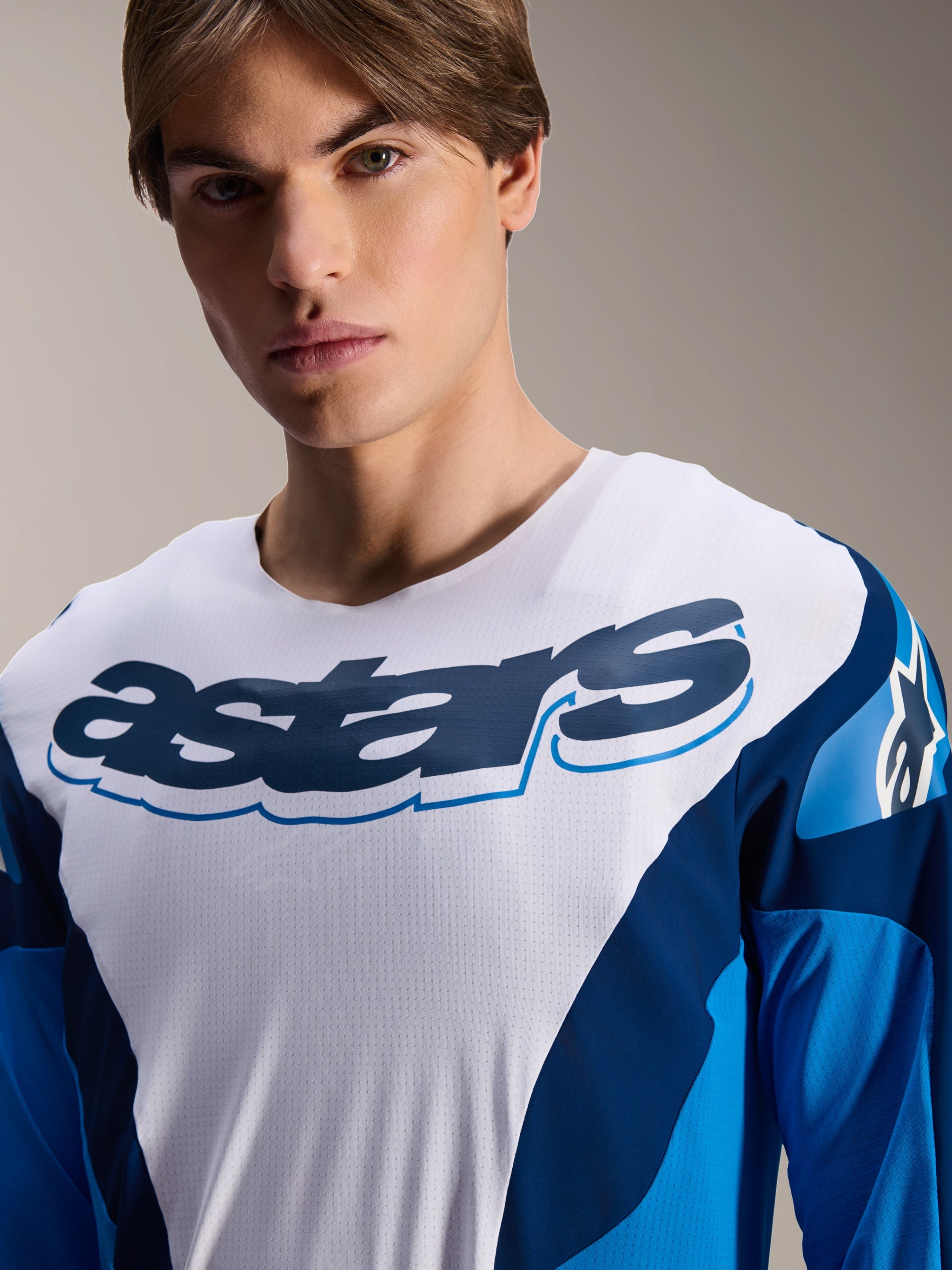 Alpinestars A-Supra Melt Jersey, Long Sleeve MTB Jersey, Blue and White with navy graphics, featuring a large 'astars' logo on the chest, micro-perforated performance material, athletic fit for mountain biking