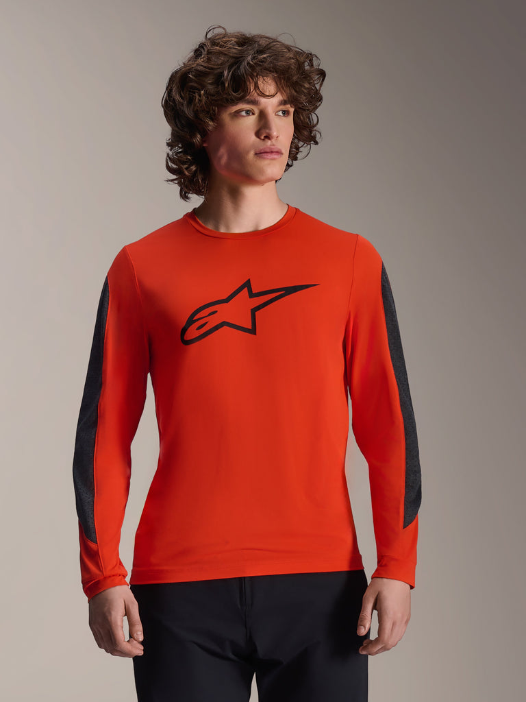 Alpinestars A-Dura Insert Astar Jersey - Long Sleeve, Spicy Orange with black Astar logo, featuring dark gray durable sleeve inserts, worn by a male model, performance MTB cycling apparel