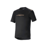 Alpinestars A-Aria Polartec Switch Short Sleeve Jersey, Black mountain bike jersey, bronze-toned Alpinestars branding on chest and shoulders, technical moisture-wicking fabric, performance fit with drop tail hem