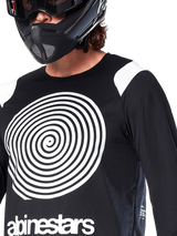 Alpinestars A-Supra Oscar Jersey, Long Sleeve, Black, featuring a large white Oscar spiral graphic on the chest and brand logo, worn by a rider with a black full-face helmet and goggles, performance mountain bike apparel for gravity riding