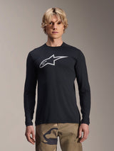 Alpinestars A-Dura Astar Long Sleeve Jersey, Black with silver Astars logo on the chest, worn by a model with camouflage pants, casual MTB performance apparel for mountain biking