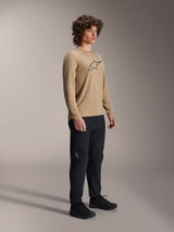 Alpinestars A-Dura Astar Long Sleeve Jersey, Light Brown, worn by a model with black pants and shoes, featuring a grey Astars logo on the chest, casual mountain bike performance gear