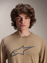 Alpinestars A-Dura Astar Long Sleeve Jersey, Light Brown, worn by male model, featuring a large Astars logo on the chest, jacquard fabric texture, casual mountain bike apparel