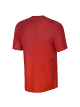 Alpinestars Youth A-Dura Rise Short Sleeve Jersey, Back View, Spicy Orange, featuring a jacquard fabric texture, a small black Astars logo on the lower side, and a dropped tail hem for mountain biking coverage.