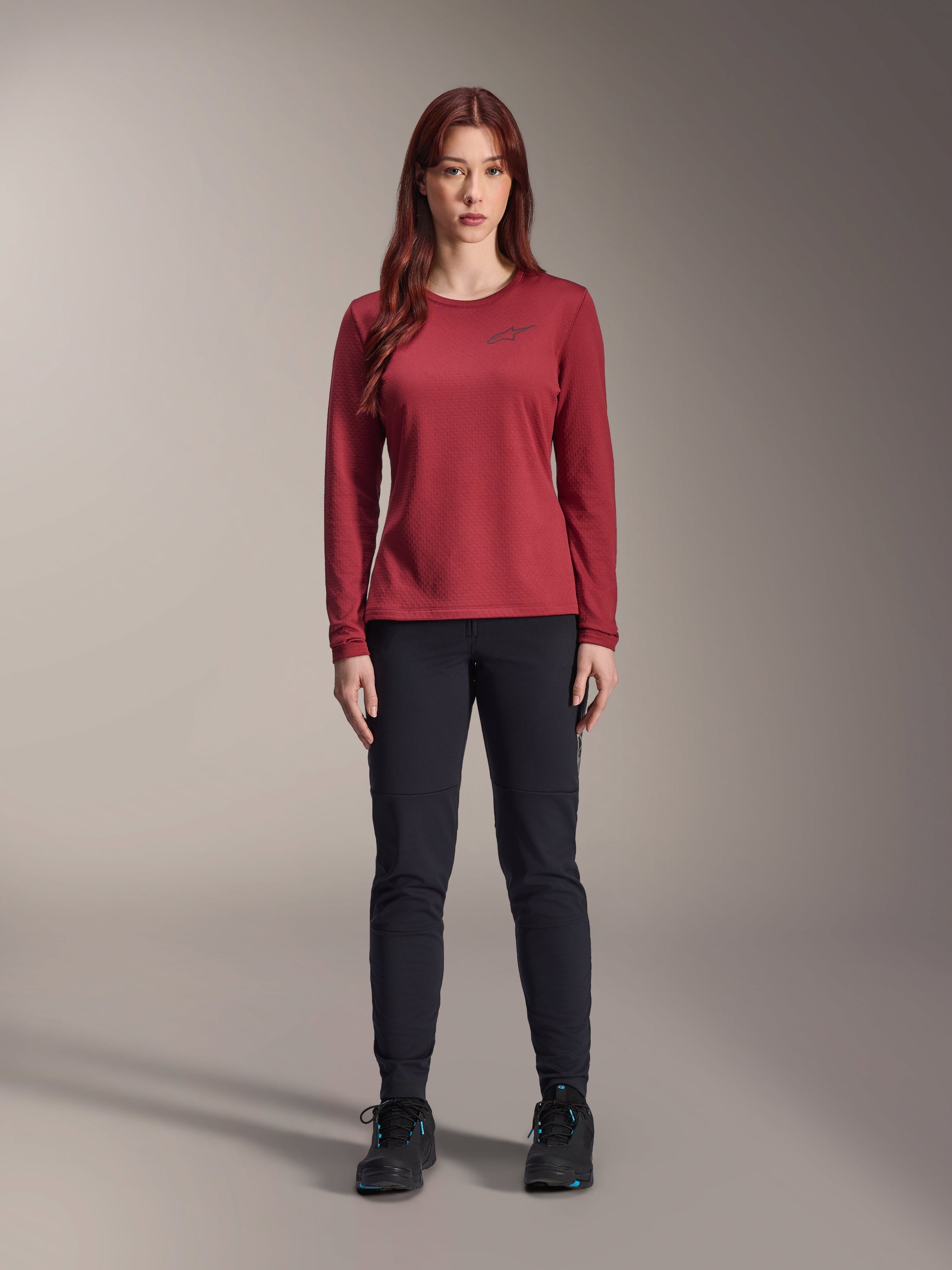 Alpinestars Stella A-Dura Thermal Pant, Women's MTB Pants, Black, worn with a maroon long-sleeve technical jersey, slim-fit thermal design for cold weather cycling, durable outer shell with brushed fleece lining