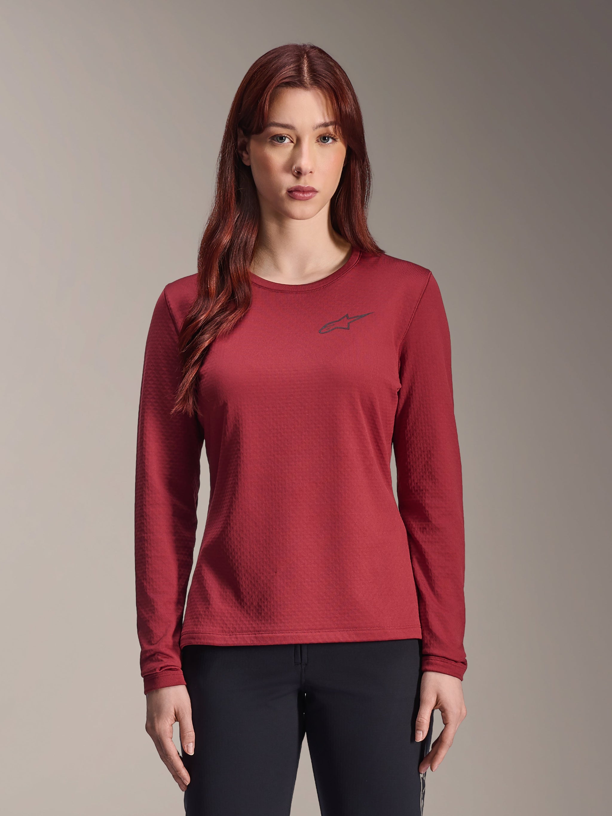 Alpinestars Stella A-Dura Thermal Jersey, Women's Long-Sleeve MTB Jersey, Burgundy, textured thermal fabric, crew neck with a small black Alpinestars logo on the chest, worn by a model.