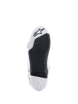 Alpinestars Tech 10 Supervented Boots, White and Black sole view, featuring an extended honeycomb grip design, black replaceable central insert, white toe with Alpinestars star logo, optimized for motocross footpeg control.