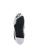 Alpinestars Tech 10 Supervented Boots sole, bottom view featuring a black and white dual-compound design, honeycomb grip texture, replaceable central insert, and embossed Alpinestars logo, optimized for motocross foot-peg performance.