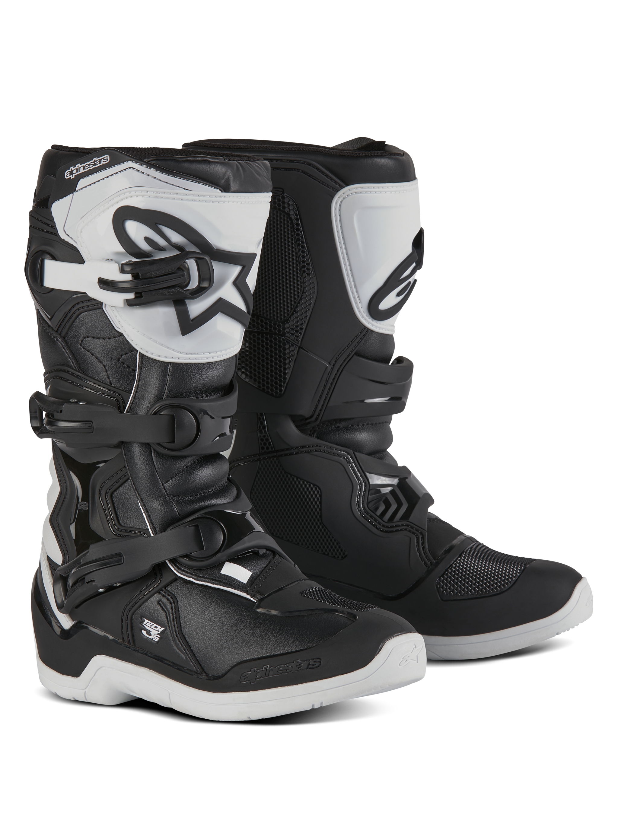 Alpinestars Youth Tech 3S Boots, Motocross Boots for young riders, Black and White, featuring three adjustable buckle straps, white TPU shin plate with Alpinestars logo, reinforced hard shell protection, and a sturdy white treaded sole, off-road racing design