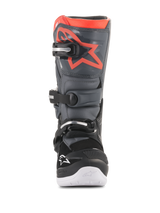 Alpinestars Youth Tech 7S Boots, Motocross Boots, Black and Dark Gray with Fluorescent Red accents, front view, featuring TPU shin plate with red star logo, three buckle closure system, and white integrated sole, durable off-road protective gear