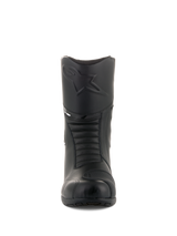 Alpinestars Andes V2 Drystar® Boots, Black Touring Motorcycle Boots, Front view showing embossed Alpinestars logo on the shin, accordion flex zones for movement, leather construction with a textured shift pad