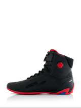 Alpinestars Honda Faster-4 Shoes, Motorcycle Riding Shoes, Black and Red, side profile view, featuring a bright red sole and hexagonal ankle protector, high-top sneaker style with lace closure and hook-and-loop strap, 'Alpinestars Protects' branding, sleek performance footwear for road riding