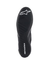 Alpinestars Supertech Shoes, Auto Racing Shoes, Black, bottom view of the ultra-thin rubber outsole with white star logo and alpinestars wordmark, featuring an asymmetric tread pattern for pedal sensitivity and grip