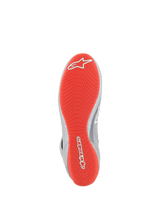 Alpinestars Tech-1 Z V3 Shoes FIA, Auto Racing Shoes, Dark Silver Black Red, Bottom view showing the bright red rubber outsole with white Alpinestars logos, textured asymmetric tread pattern for grip, silver leather accents on the side