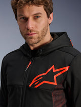 Alpinestars Chrome Air Sport Hoodie, Black and Red Fluo, close-up shot showing the large red fluo star logo on the chest, red mesh side panels for ventilation, zippered front, and snap-button collar, casual urban motorcycle riding gear
