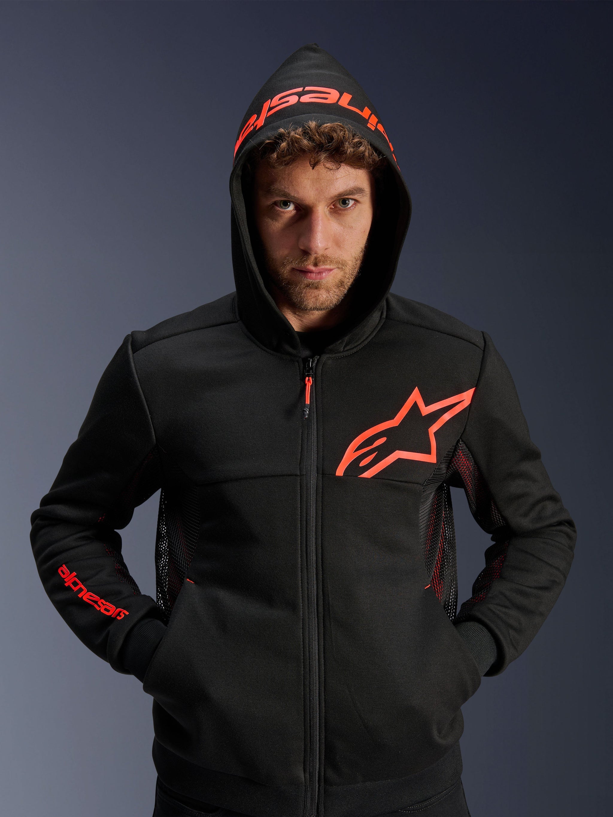Alpinestars Chrome Air Sport Hoodie, Black and Red Fluo, urban motorcycle hoodie featuring mesh ventilation panels, red Astar logo on the chest, and branded hood, casual riding gear for urban environments.