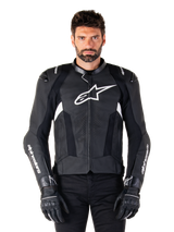 Alpinestars Missile V3 Leather Jacket, Black with White Logos, worn by a model with black riding gloves, premium leather motorcycle racing jacket with perforated ventilation panels and performance riding features