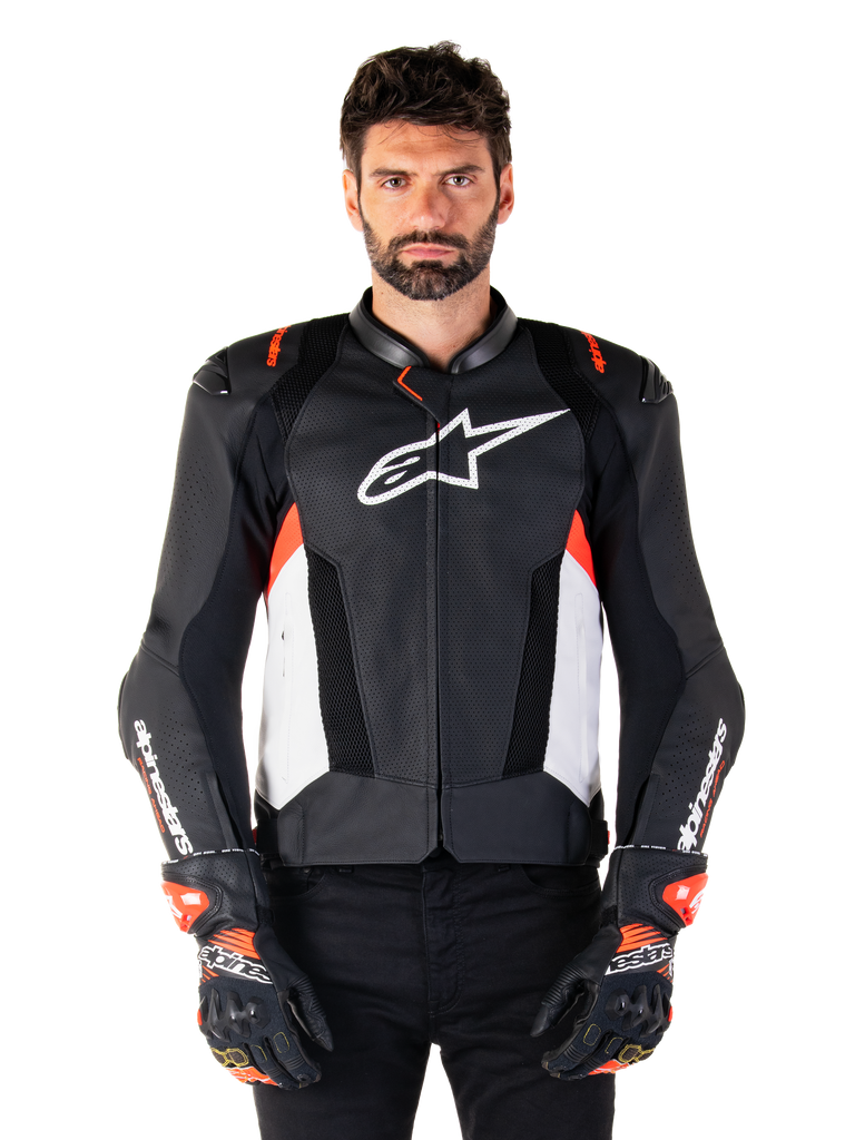 Alpinestars Missile V3 Airflow Leather Jacket, Motorcycle Racing Jacket, Black and White with Red Fluo accents, perforated ventilation panels, white star logo on chest, worn with black and red gloves, premium leather construction