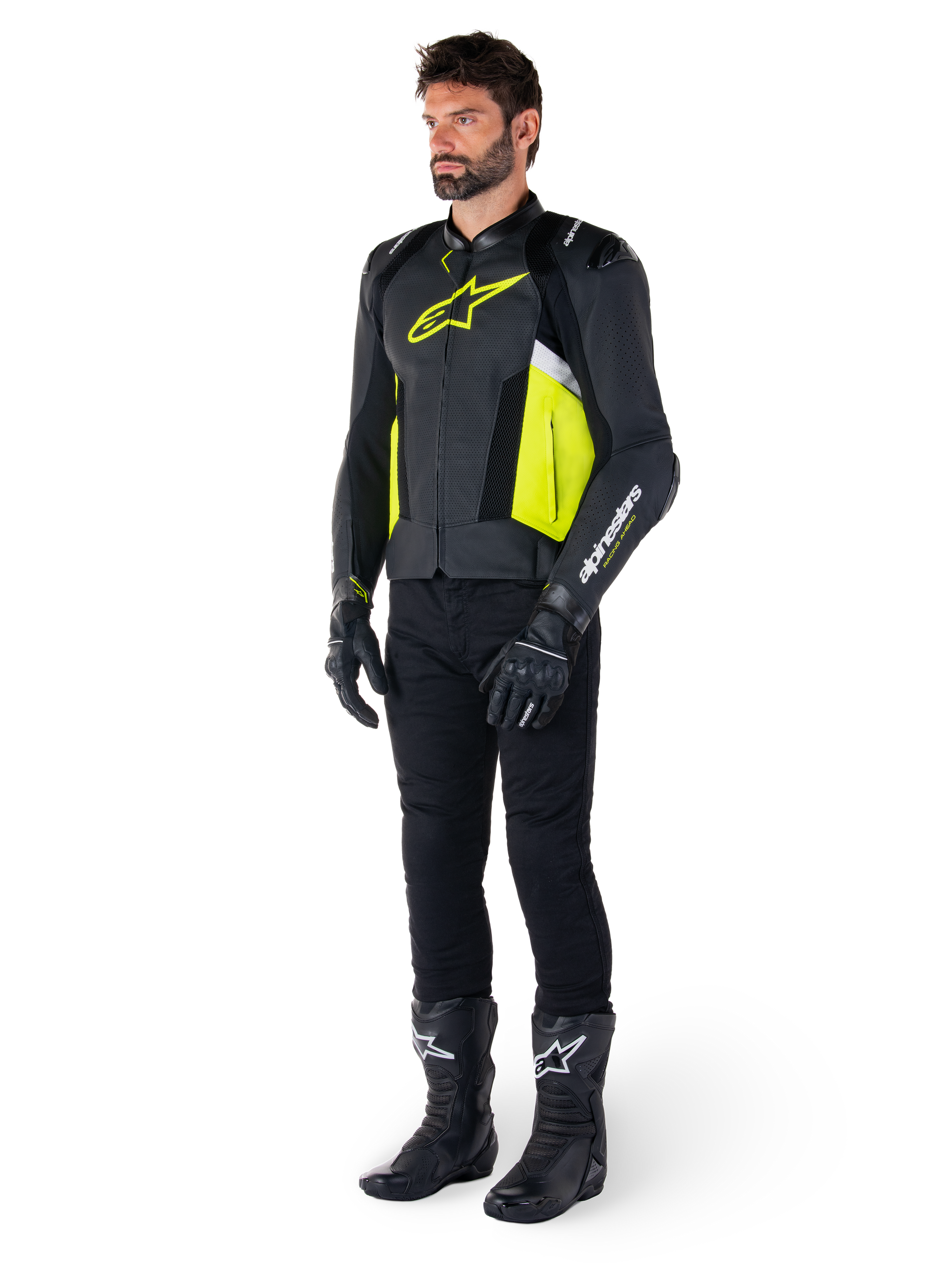 Male model wearing the Alpinestars Missile V3 Airflow Leather Jacket in Black, Yellow Fluo, and White, styled with black riding gloves, pants, and boots, showcasing the perforated leather design and racing-inspired aesthetic.