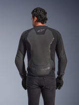Alpinestars GP Force V2 Leather Jacket, Black, Rear view of a man wearing the jacket with black gloves and jeans, featuring large leather protective panels on the back, Alpinestars logo on the upper back, and embossed branding at the lower waist, sport-inspired motorcycle riding gear