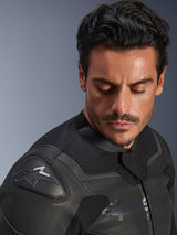 Alpinestars GP Force V2 Leather Jacket, Black, close-up of a male model wearing the jacket, focusing on the shoulder featuring the GP Lite Evo DFS protector and Alpinestars logo, premium multi-panel leather construction