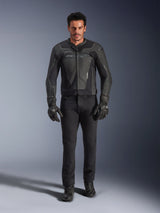 Alpinestars GP Force V2 Leather Jacket in Black, worn by a male rider with black motorcycle pants, gloves, and boots, sleek sport-style leather construction with shoulder sliders and integrated protection.