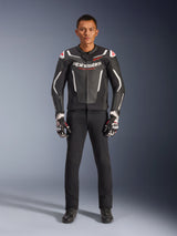 Male model wearing Alpinestars GP Force V2 Leather Jacket in Black and White, paired with black motorcycle pants and black and white gloves, featuring bold Alpinestars branding and red shoulder accents, professional sport motorcycle riding gear
