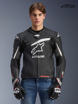Alpinestars GP Plus R V4 Rideknit Leather Jacket, men's racing motorcycle jacket in black and white, front view on a model wearing matching gloves and jeans, race-derived protection and engineered stretch panels.