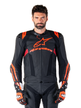 Alpinestars Missile V3 Ignition Leather Jacket, Motorcycle Racing Jacket, Black and Red Fluo, worn with matching racing gloves and leather pants, featuring perforated ventilation and prominent Alpinestars branding, professional racing gear