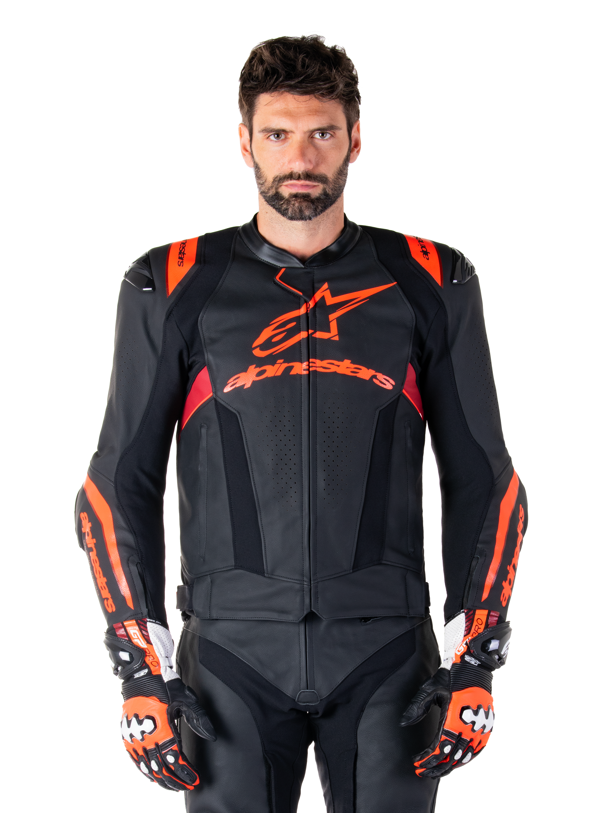 Alpinestars Missile V3 Ignition Leather Jacket, Motorcycle Racing Jacket, Black and Red Fluo, worn with matching racing gloves and leather pants, featuring perforated ventilation and prominent Alpinestars branding, professional racing gear