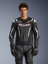 Alpinestars GP Force V2 Air Leather Jacket, Black with White and Red accents, model wearing perforated leather jacket with 'alpinestars' and 'RACING AHEAD' branding on the chest, paired with matching racing pants and gloves, premium sport motorcycle gear