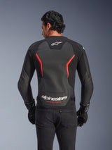 Alpinestars GP Force V2 Air Leather Jacket, back view, Black and Red Fluo, featuring a large perforated leather back panel for ventilation, 'Alpinestars Racing Ahead' branding on the lower back, worn by a rider with black gloves, performance sport motorcycle gear