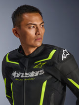 Alpinestars GP Force V2 Air Leather Jacket, Black and Yellow Fluo, perforated sport motorcycle jacket featuring white chest logo with 'Racing Ahead' text, neon accents, and protective shoulder sliders, worn by a male model.