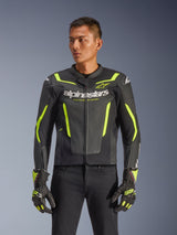 Alpinestars GP Force V2 Air Leather Jacket, Black and Yellow Fluo, perforated leather motorcycle jacket with protective armor and neon accents, worn with matching racing gloves and black pants, athletic sport fit with bold branding