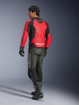 Alpinestars GP Force V2 Air Leather Jacket, Red and Black, rear view on a motorcycle rider, worn with black leather pants and racing boots, featuring perforated back panels and Alpinestars branding