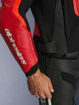 Alpinestars GP Force V2 Air Leather Jacket, Red and Red Fluo, close-up of perforated leather sleeve with bold white Alpinestars logo, black textured panels, and waist attachment zipper, premium sport riding protection