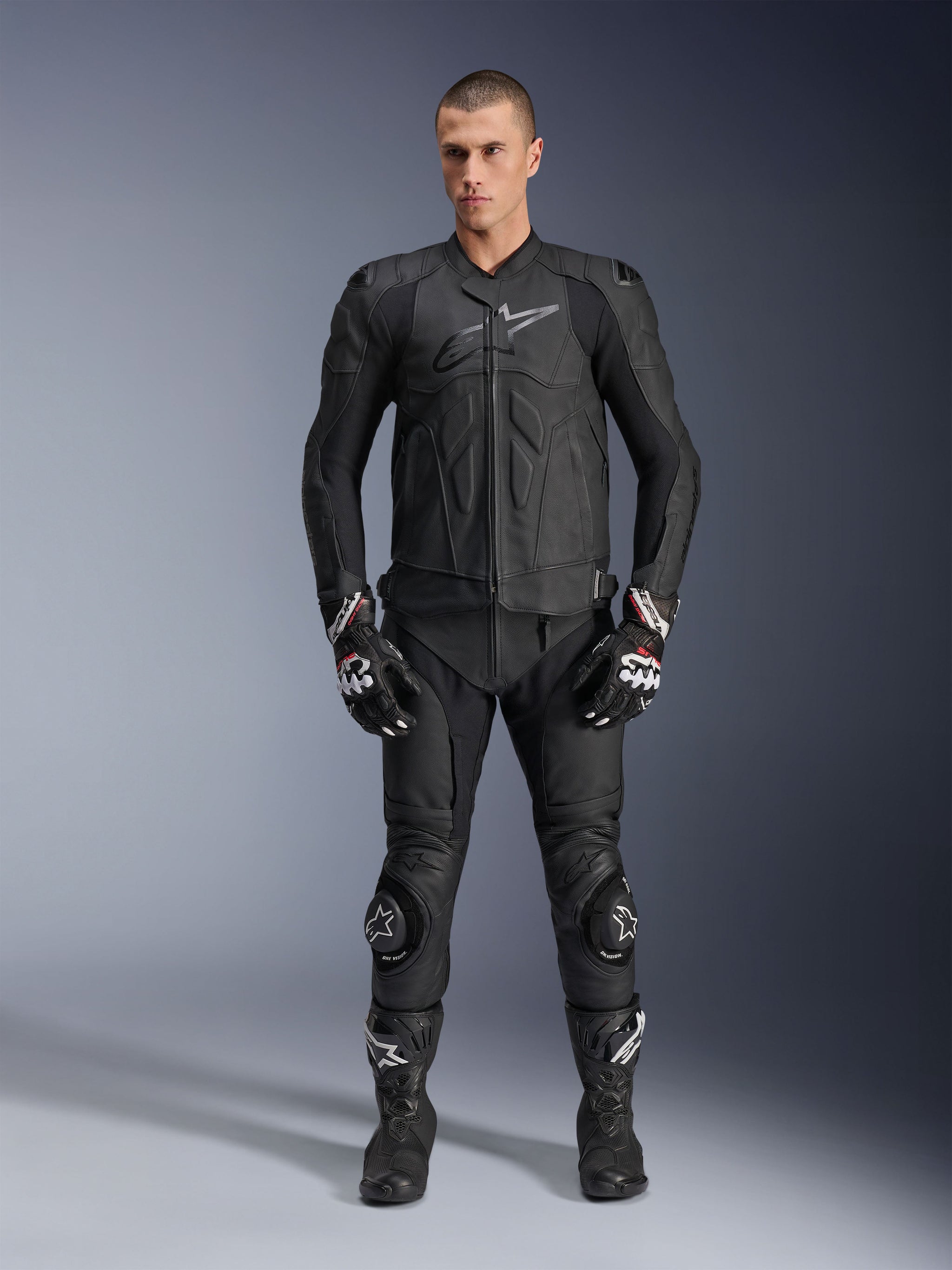 Alpinestars Dusk Leather Jacket, black bovine leather sport motorcycle jacket, worn by male model in full racing gear.