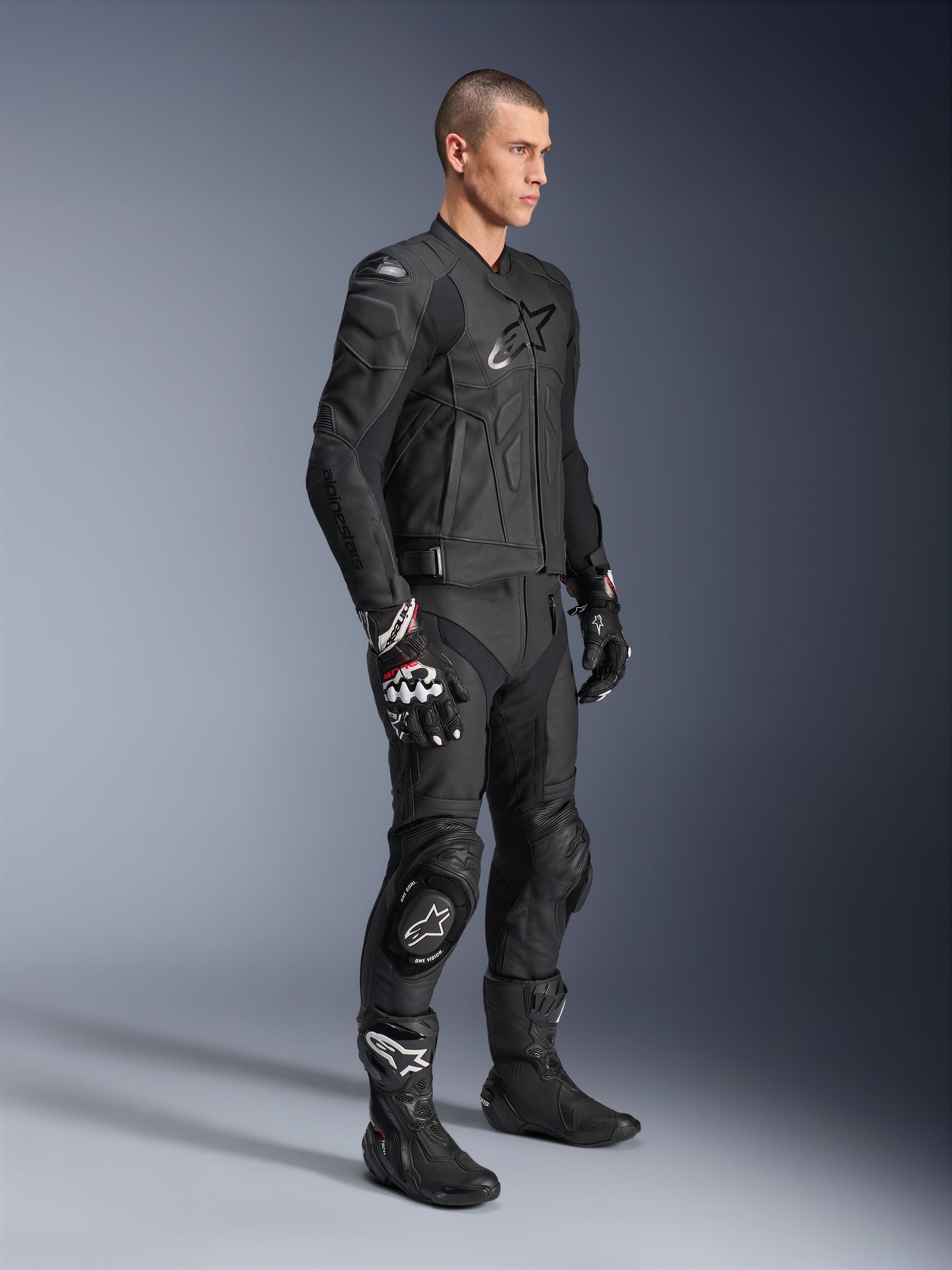 Alpinestars Missile V3 Leather Pants, paired with a matching black leather jacket, gloves, and boots, featuring knee sliders and a sleek racing fit, all-black motorcycle protective gear for track and road riding.