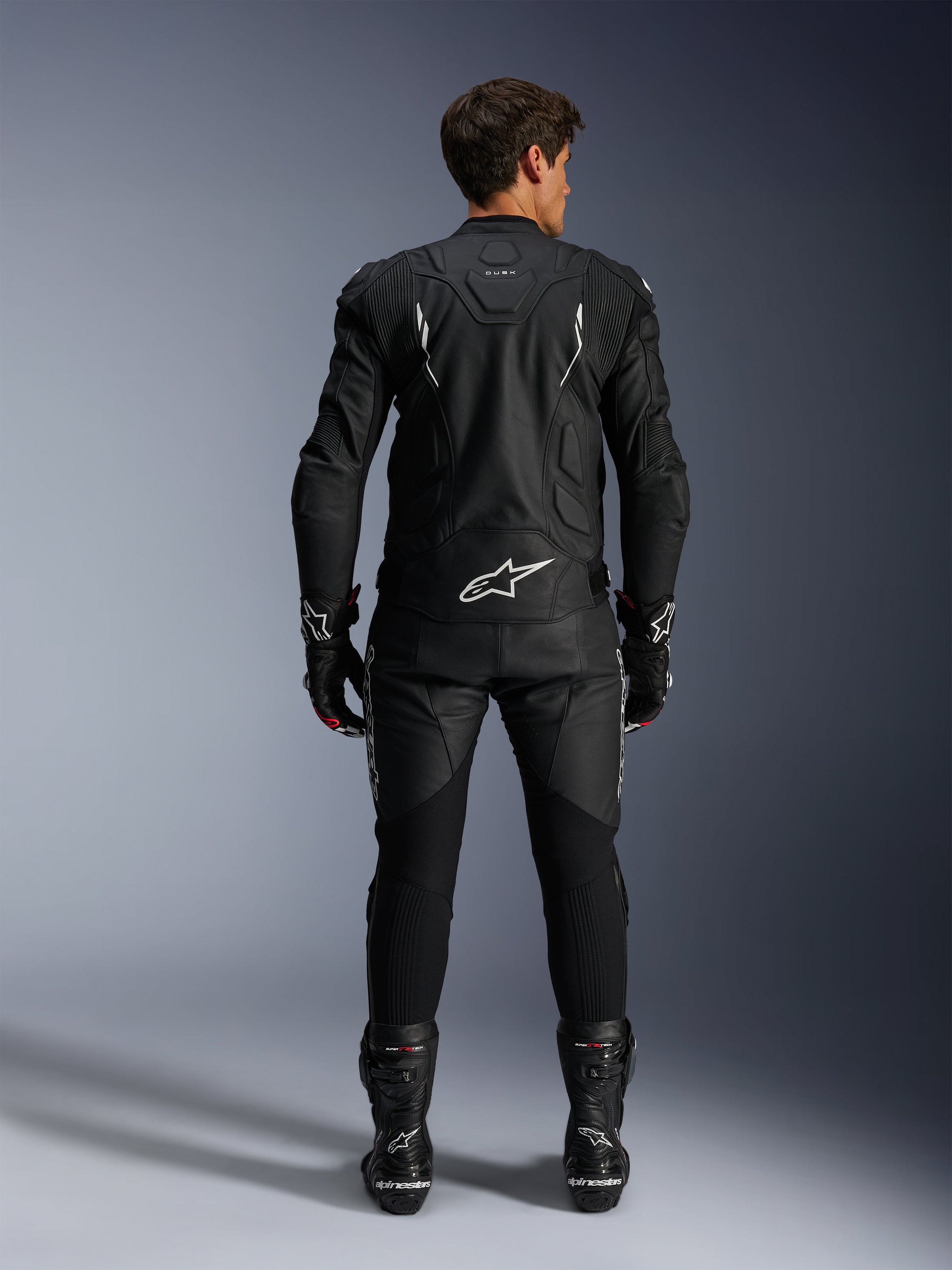 Alpinestars Dusk Leather Jacket AND Missile V3 Leather Pants, men's black and white leather racing suit, rear view.