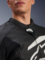 Alpinestars GP Plus V4 Leather Jacket, Sport Motorcycle Jacket, Black and White, close-up of textured leather collar and Alpinestars logo tab, white graphic on chest, race-derived design
