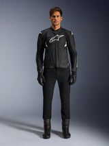 Alpinestars Dusk Airflow Leather Jacket, Black and White, motorcycle leather jacket with perforated panels for airflow, white Astars logo on chest, worn by a male rider with black pants, gloves, and riding boots, professional studio shot for sport motorcycle gear.
