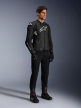 Alpinestars Dusk Airflow Leather Jacket, Black and White, modeled with black motorcycle pants, gloves, and boots, featuring perforated leather panels and white logo branding, sport road racing style.
