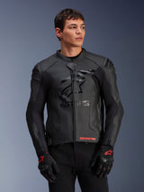 Alpinestars GP Plus R V4 Airflow Leather Jacket, Black, Motorcycle Racing Jacket with perforated leather construction, featuring prominent ASTARS chest branding and DFS shoulder protection, worn with black and red gloves
