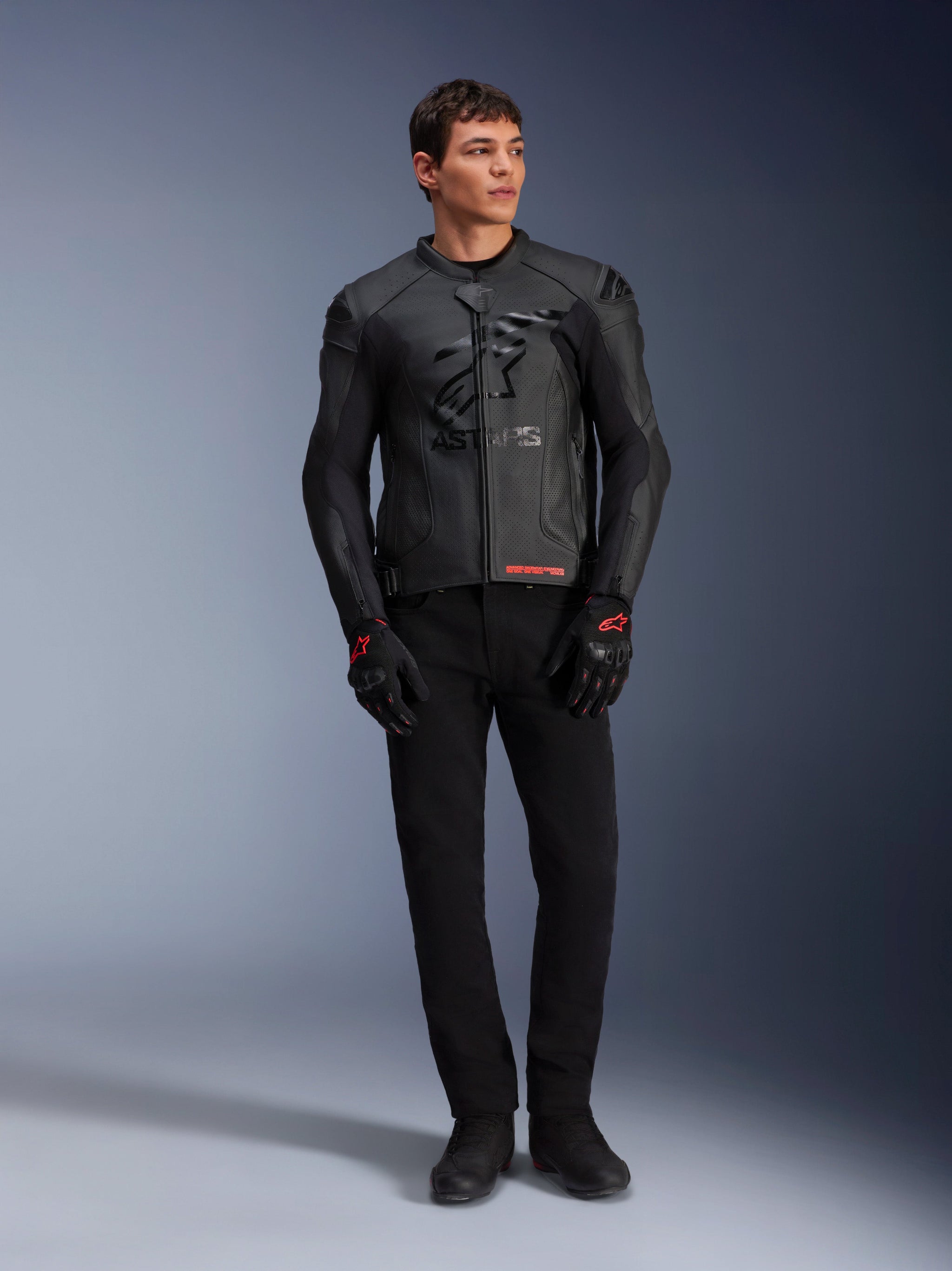 Alpinestars GP Plus R V4 Airflow Leather Jacket, Black, worn by a male model with matching black gloves and pants, featuring perforated leather panels, large tonal star logo on the chest, and sleek sport riding fit