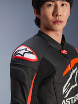 Alpinestars GP Plus R V4 Airflow Leather Jacket, Black Red Fluo White, close-up of model wearing the jacket, featuring prominent Astar logo on the shoulder slider and perforated leather chest for maximum airflow, professional motorsport apparel