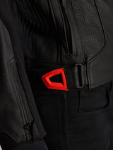 Alpinestars GP Plus R V4 Airflow Leather Jacket close-up, black perforated leather with a vibrant red fluo hook-and-loop waist adjustment strap, featuring a zippered side pocket and ergonomic textured panels.