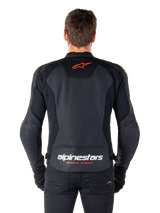 Alpinestars Faster V3 Airflow Leather Jacket, Black, rear view featuring perforated leather panels for ventilation, red Alpinestars star logo, and white branding on the lower back, worn with black pants and gloves.