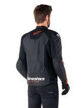Alpinestars Faster V3 Airflow Leather Jacket, Sport Motorcycle Jacket, Black with Red Fluo, back view, featuring perforated leather panels, orange-red Alpinestars logo on upper back and white branding on the lower back, worn with black pants and gloves, sleek race-derived style